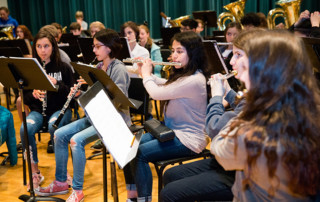 Middle school honor band students rehearse before a concert